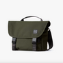 An olive Classic Messenger Bag with black straps and buckles, featuring a top carrying handle, set against a white background.