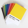 A fanned-out set of Pantone color swatch cards on a white background, with the top card showing a bright yellow color block labeled 'PANTONE 14-0760 Cyber Yellow'.