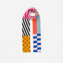 Skinny knit scarf in various blocks of bright colors with varying stripe and check patterns against white background.