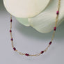 Tuvana Necklace with Rubies, ruby & gold chain necklace, close up, flower petals