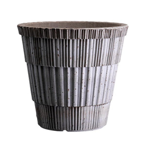 Hand crafted textured terracotta plant pot with speckled gray glaze, white background
