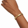 yellow bronze cuff bracelet on wrist