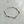 Silver bracelet on a light gray background