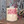 Nutscape Deep Orchid garden twine canister with pink twine on a rustic wooden surface.