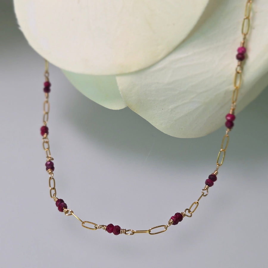 Tuvana Necklace with Rubies, ruby & gold chain necklace, close up, flower petals