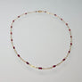 Tuvana Necklace with Rubies on a light gray background