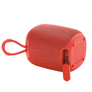 A red portable Bluetooth speaker with a carrying loop and a side USB charging port, shown on a solid white background.