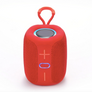 A red portable Bluetooth speaker with a carrying loop on top, featuring a textured mesh front, a circular top speaker grille, and simple front-facing control buttons with blue LED accents, shown on a white background.