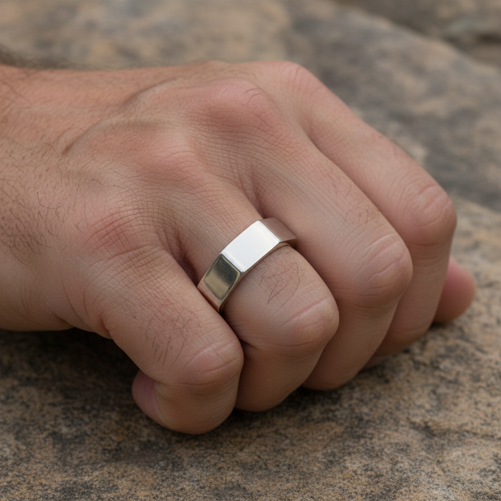 Vincent Ring, close up of man's hand wearing white bronze bolt design ring